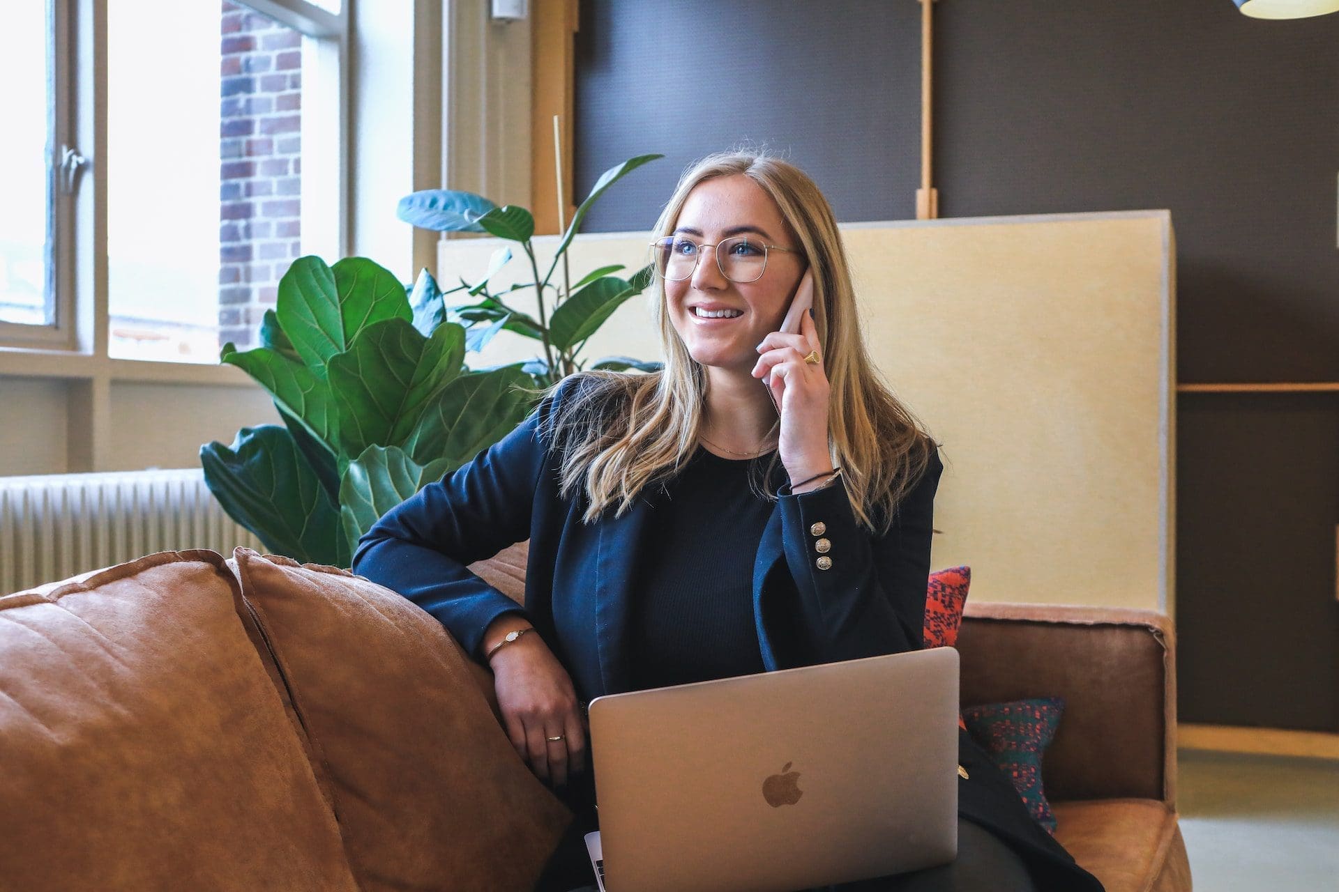 a smiling woman talking on the phone