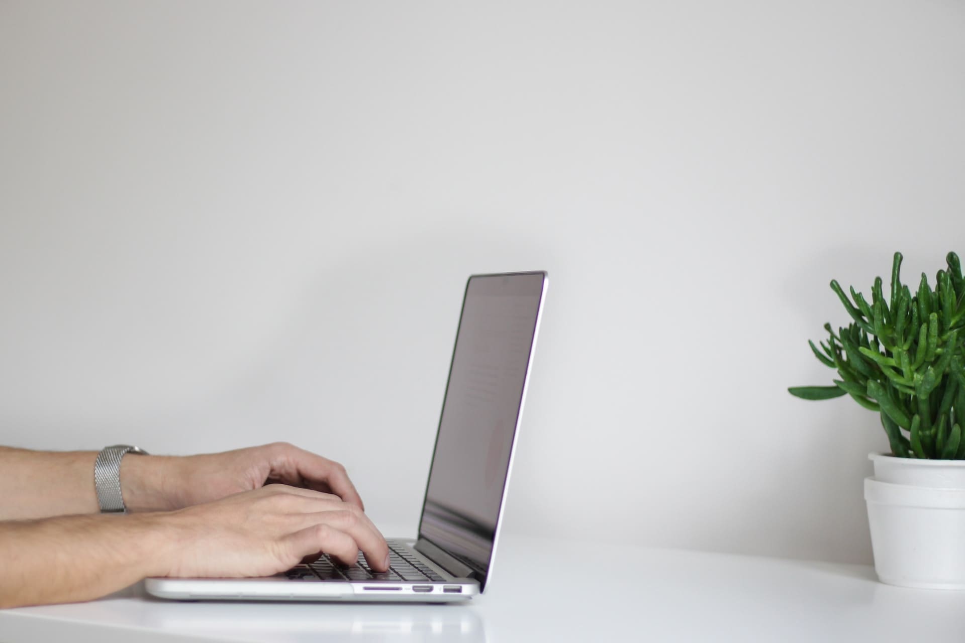 a person typing on a laptop