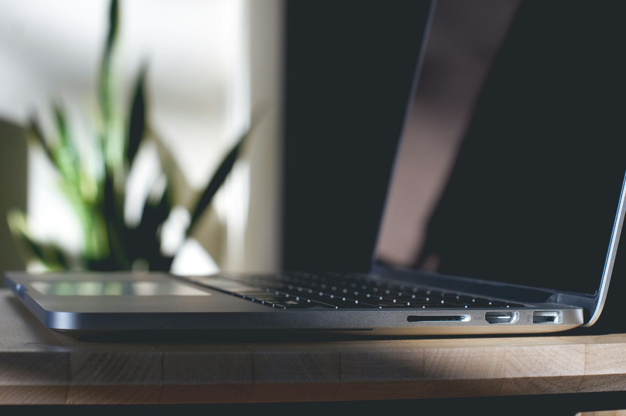grey macbook on top of table